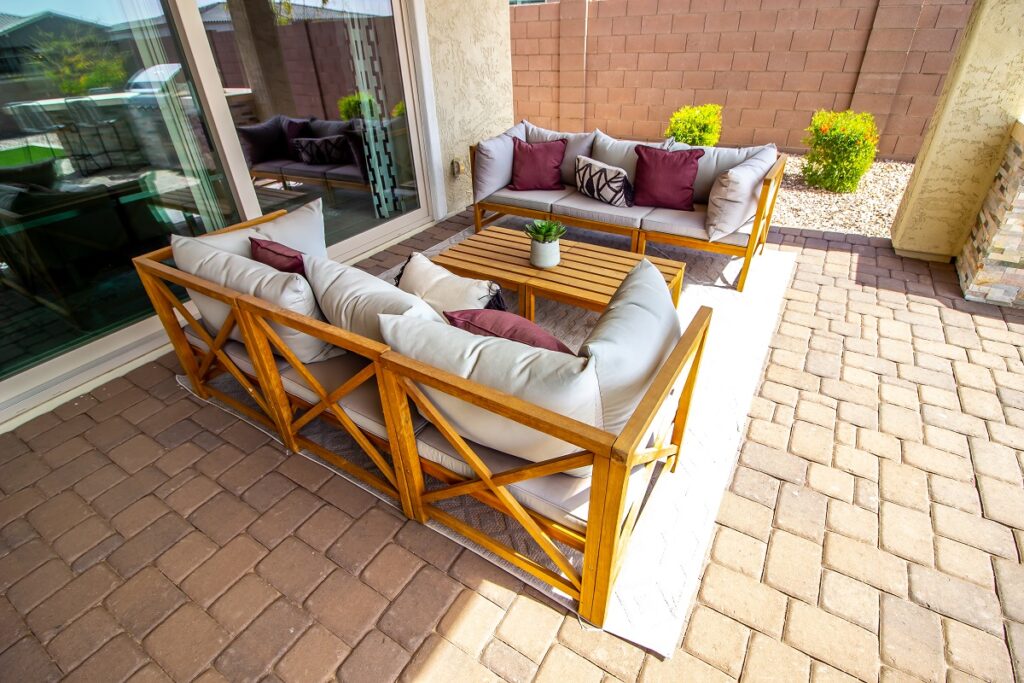 An image of an outdoor sitting area with freshly sealed pavers.